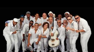 A group of people in white clothes holding instruments.