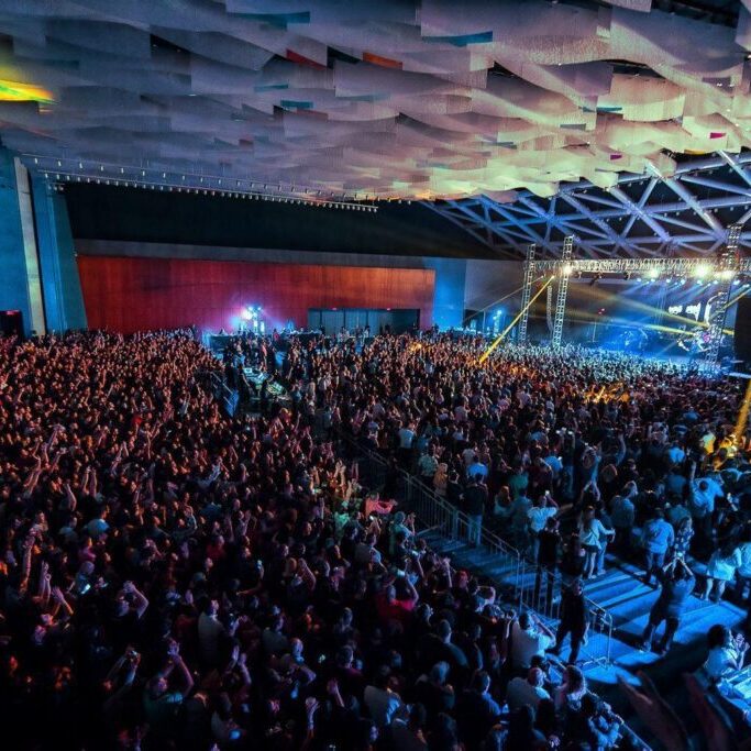 A large crowd of people in an auditorium.