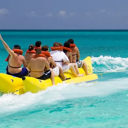 A group of people riding on the back of a raft.