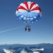 A parasailing boat with two people on it.